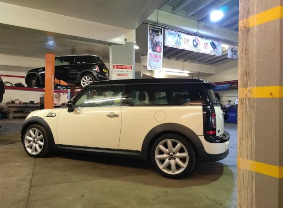Inside the workshop: a Mini on the ramp and another on the floor
